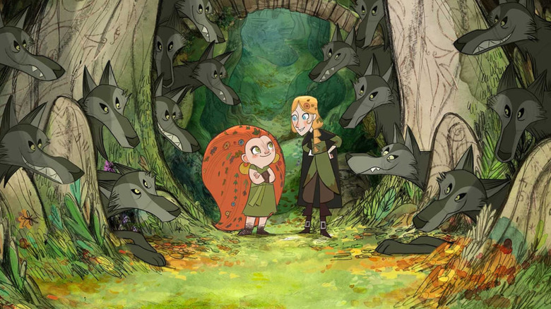Mebh, animated young girl with red hair down to the ground and Robyn, taller girl with blonde hair, surrounded by wolves in Wolfwalkers