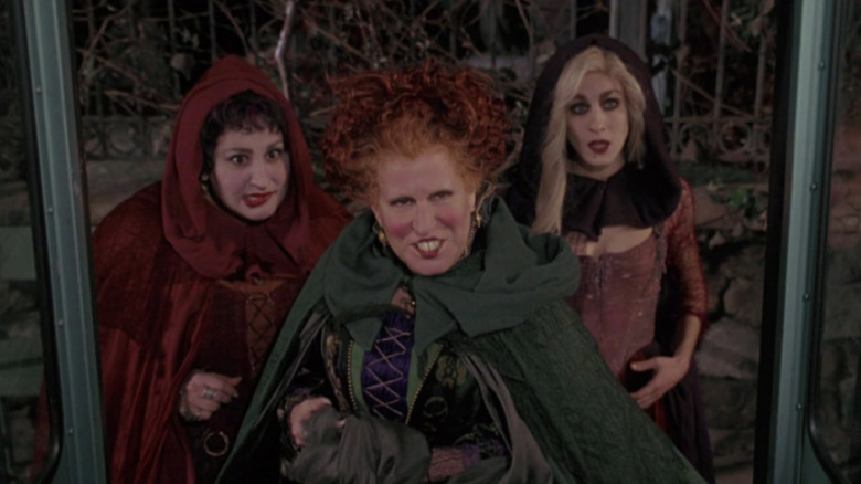 Bette Midler as Winifred Sanderson, Kathy Najimy as Mary Sanderson, and Sarah Jessica Parker as Sarah Sanderson tlaking to the bus driver in Hocus Pocus