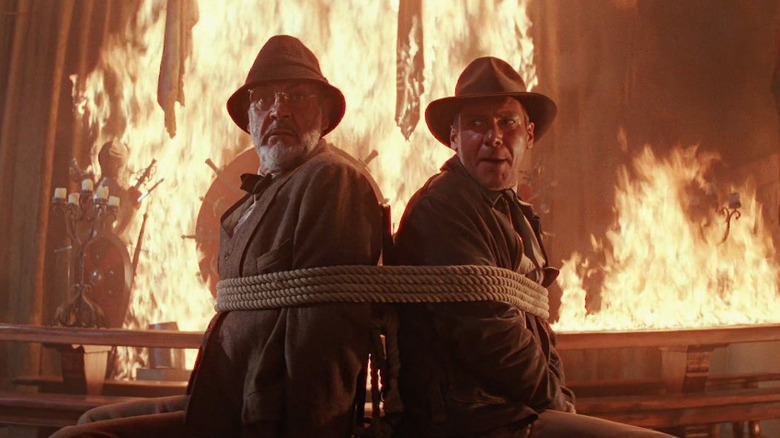 Sean Connery as Henry Jones Sr and Harrison Ford as Indiana Jones tied up and surrounded by fire in Indiana Jones and the Last Crusade