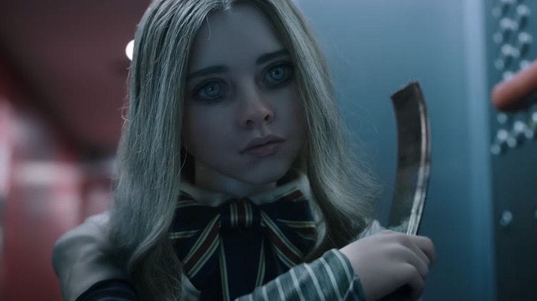 M3GAN (Amie Donald, Jenna Davis) brandishes a weapon in M3GAN