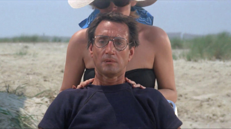 Roy Scheider as Chief Martin Brody looking out at the beach with Lorraine Gary as Ellen Brody behind him touching his shoulders in Jaws.