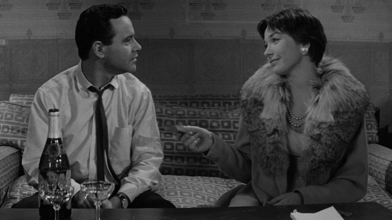 Jack Lemmon as CC Baxter sitting next to Shirley MacLaine as Fran Kubelik on a couch in The Apartment.