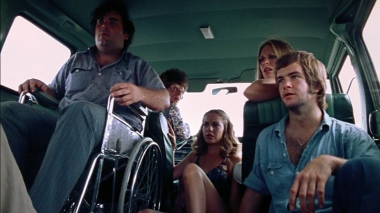 Marilyn Burns as Sally Hardesty, Teri McMinn as Pam, Paul A. Partain as Franklin Hardesty, and William Vail as Kirk, sitting together in a van in The Texas Chain Saw Massacre.