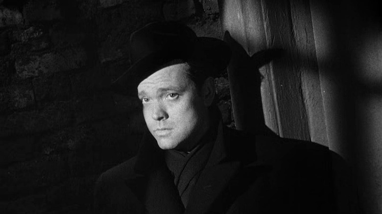 Orson Welles as Harry Lime, looking toward the middle distance, his face out of the shadows in The Third Man.