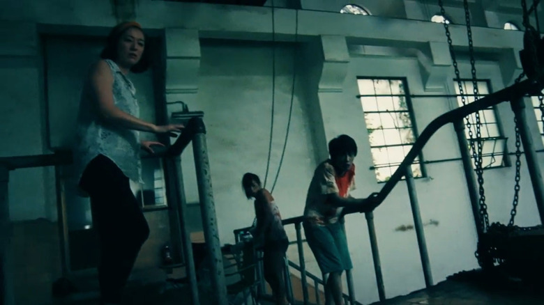 Actors confronting zombies in One Cut of the Dead