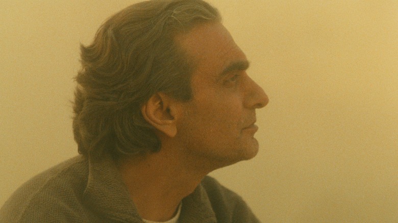 Homayoun Ershadi as Mr. Badii in tan dusty landscape in Taste of Cherry