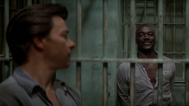 Darwin Joston as Napoleon Wilson looking at Tony Burton as Wells behind bars in Assault on Precinct 13