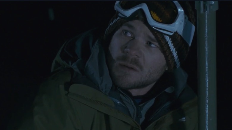 Shawn Ashmore as Joe, bundled up against the weather on a chairlift, in Frozen