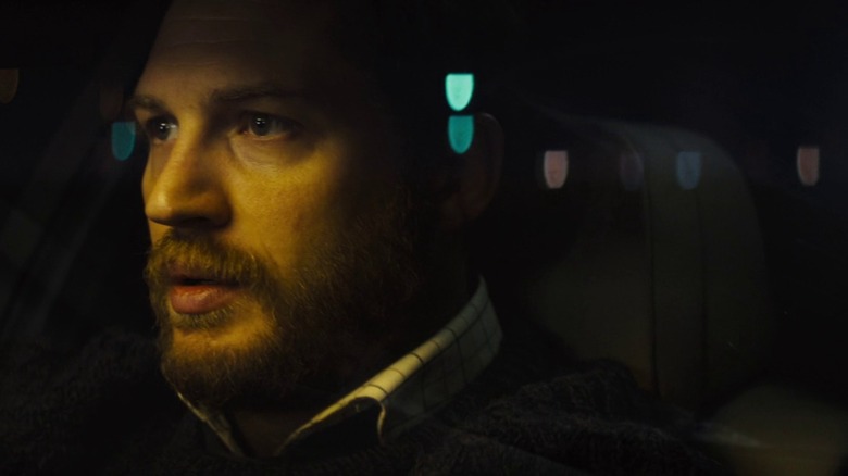 Tom Hardy as Locke with twinkling lights behind and over him, in Locke