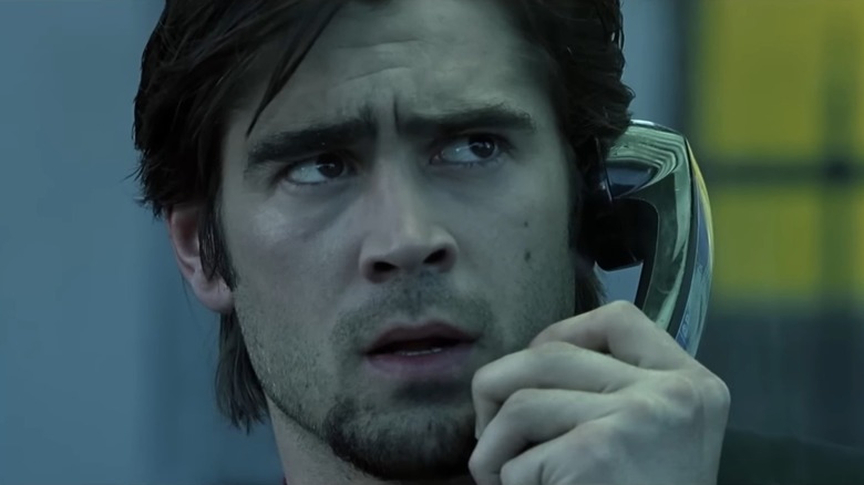 A concerned-looking Colin Farrell as Stu, holding a phone to his ear in Phone Booth