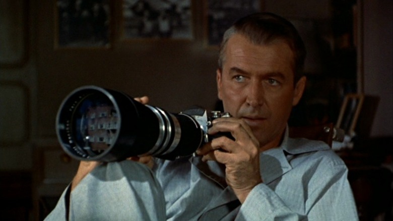 Jimmy Stewart as Jeff holding his camera in Rear Window