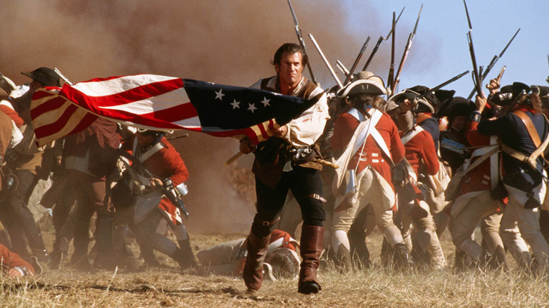 Benjamin Martin (Mel Gibson) charges with an American flag in The Patriot