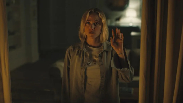 Maika Monroe as Julia, waving to someone in Watcher