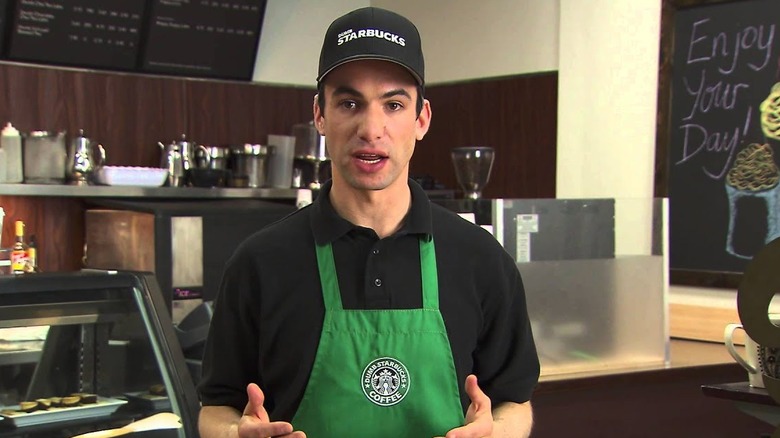 Nathan Fielder wearing Dumb Starbucks uniform in Nathan For You