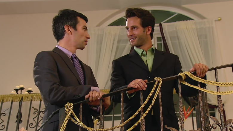 Nathan Fielder standing on a staircase with Anthony Napoli in Nathan For You