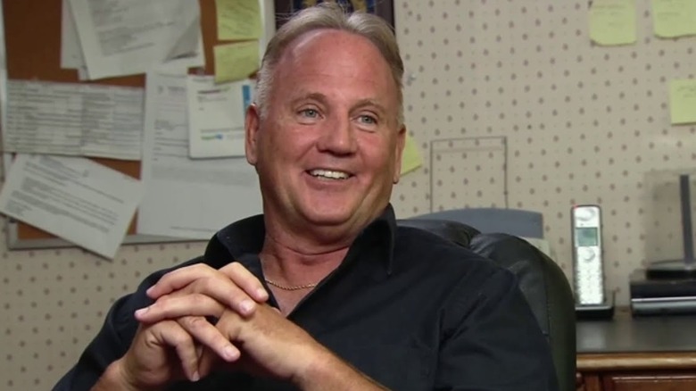 Brian Wolfe sitting in his office in Nathan For You