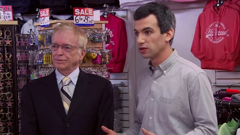 Nathan Fielder standing with a Bill Gates impersonator in a souvenir shop in Nathan For You