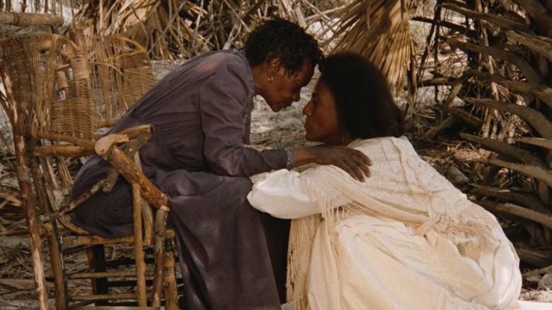 Cora Lee Day as Nana Peazant sitting on a chair and holding her face near Barbara O. as Yellow Mary in Daughters of the Dust