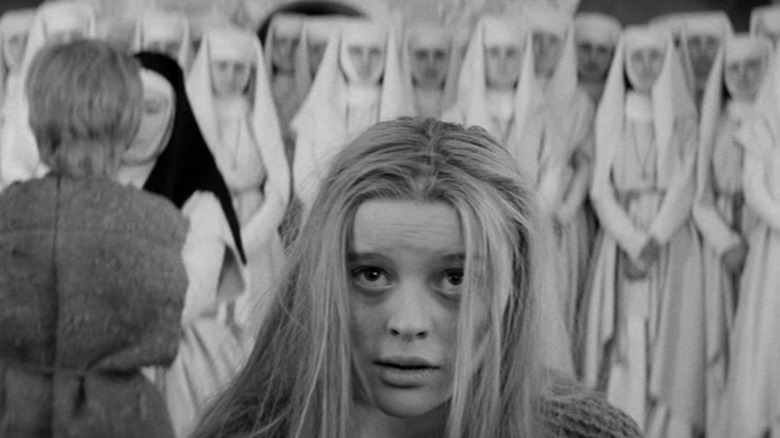 Magda Vásáryová as Marketa Lazarová standing in front of a row of nuns in Marketa Lazarová