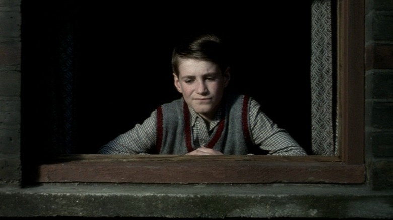 Leigh McCormack as Bud looking out a window in The Long Day Closes