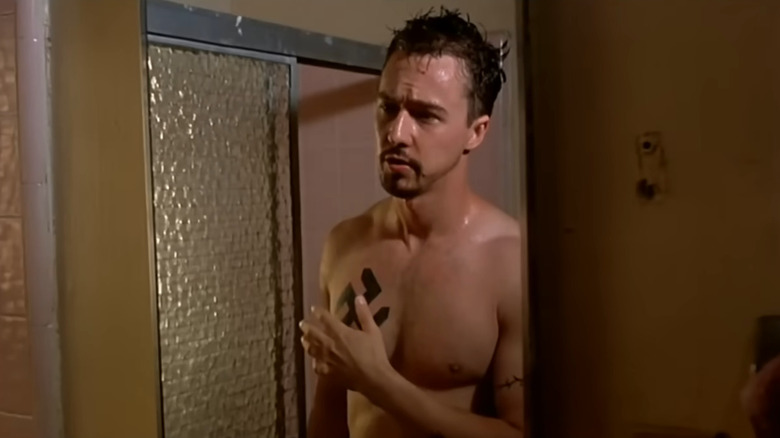 Derek (Edward Norton) covering swastika tattoo with hand in American History X