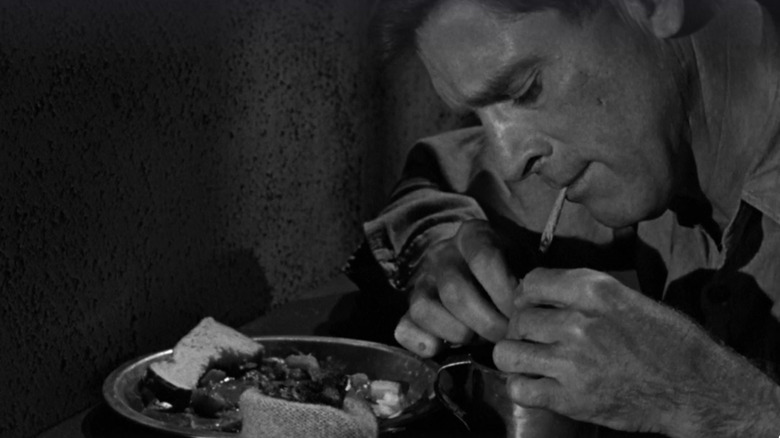 Richard (Burt Lancaster) tending to baby sparrow in Birdman of Alcatraz