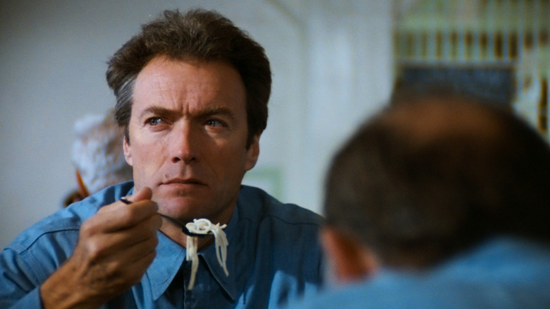 Frank Morris (Clint Eastwood) pondering escaping prison while eating in Escape from Alcatraz