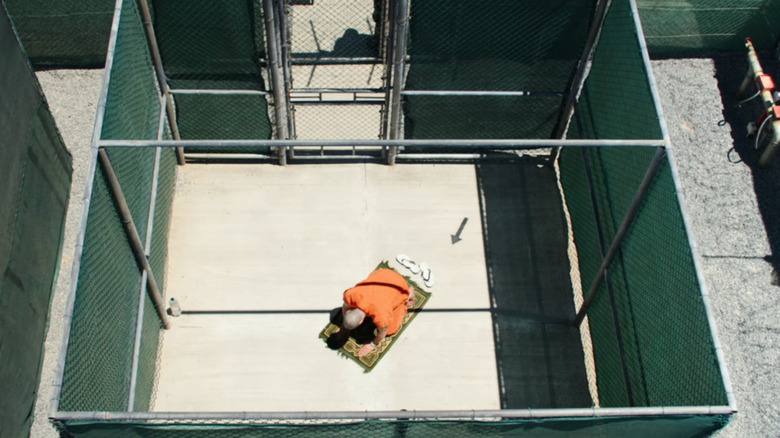 Mohamedou (Tahar Rahim) praying in prison in The Mauritanian