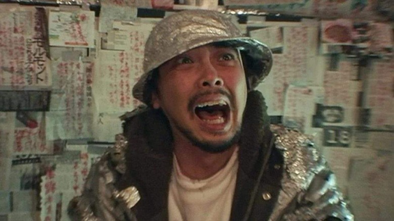 A man in a tinfoil hat screams.