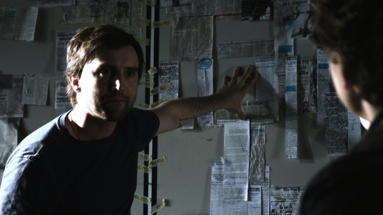 Aaron Poole wall of newspaper clippings