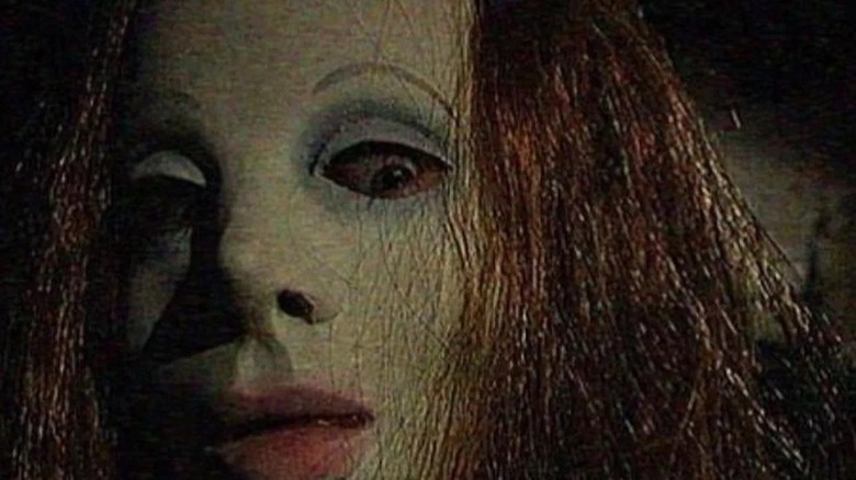 masked woman with eyes wide