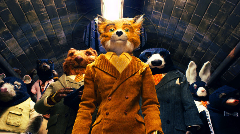 Mr. Fox (George Clooney) leads his team of masked burglars in a narrow tunnel in Fantastic Mr. Fox