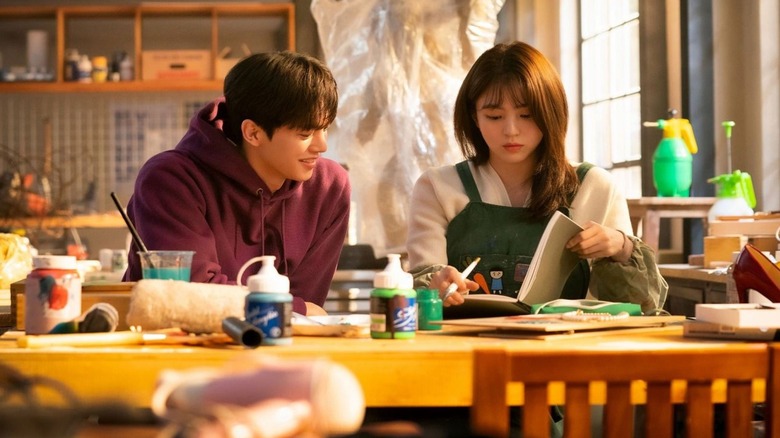 Park Jae-eon (Song Kang) sits next to Yoo Na-bi (Han So-hee) in an art studio in Nevertheless