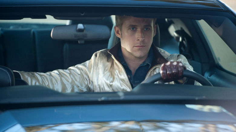 Ryan Gosling as the Driver, behind the wheel of a car in Drive