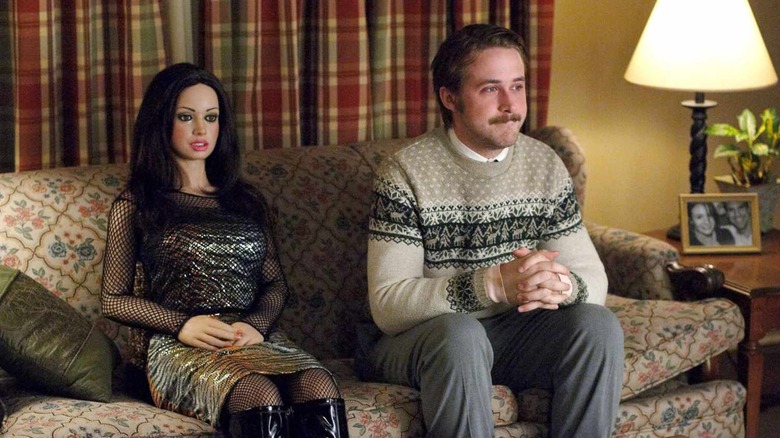 Ryan Gosling as Lars, sitting on the couch with a lifesize doll in Lars and the Real Girl
