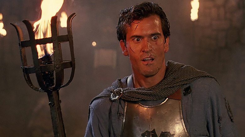 Bruce Campbell holding torch Army of Darkness
