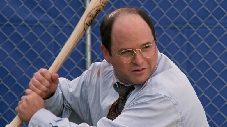 Jason Alexander as George Costanza swings a baseball bat in Seinfeld