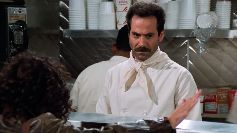 Larry Thomas as the Soup Nazi angrily watches a customer on Seinfeld