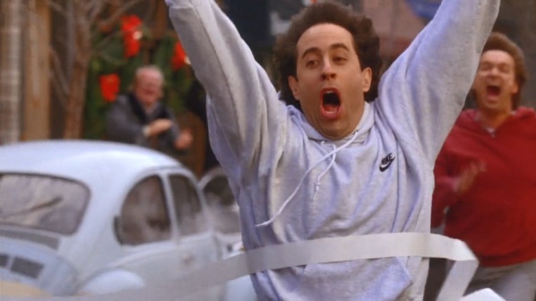 Jerry (Jerry Seinfeld) runs through ticker tape in Seinfeld