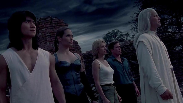 Liu Kang, Kitana, Sonya, Johnny Cage, and Raiden stare at a cloudy sky in Mortal Kombat: Annihilation