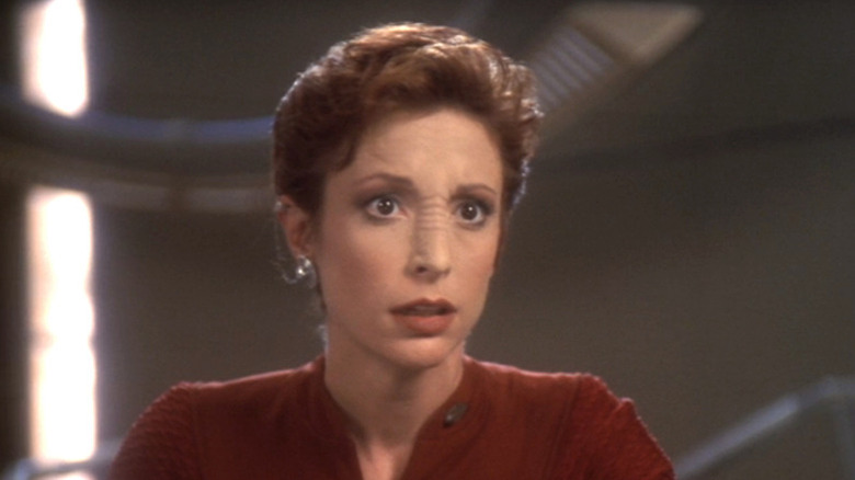 Kira Nerys (Nana Visitor) stands surprised in Star Trek: Deep Space Nine