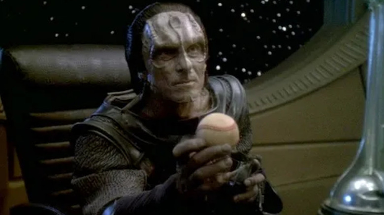 Dukat holds Sisko's baseball