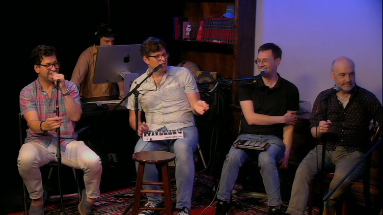 The cast of Mission to Zyxx in front of microphones