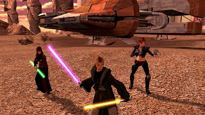 Two Jedi and smuggler stand by a parked Ebon Hawk in Star Wars: Knights of the Old Republic II - The Sith Lords