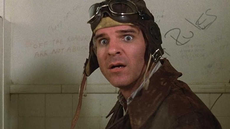 Navin looking surprised wearing aviator cap The Jerk