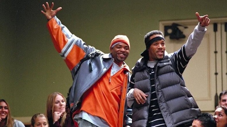 Silas and Jamal smiling with arms raised