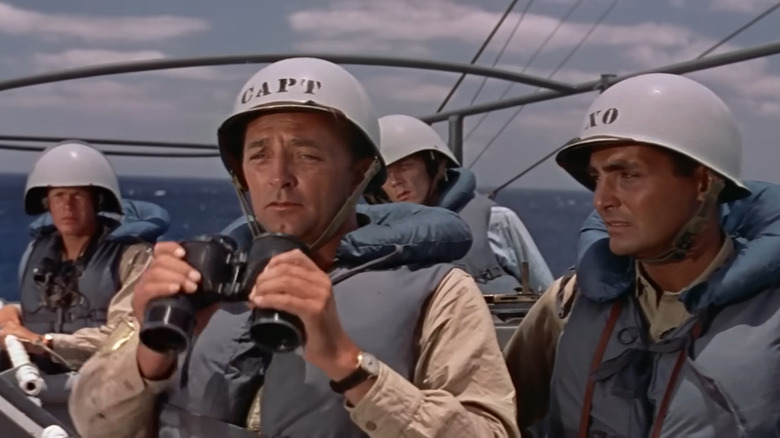 Robert Mitchum holds binoculars