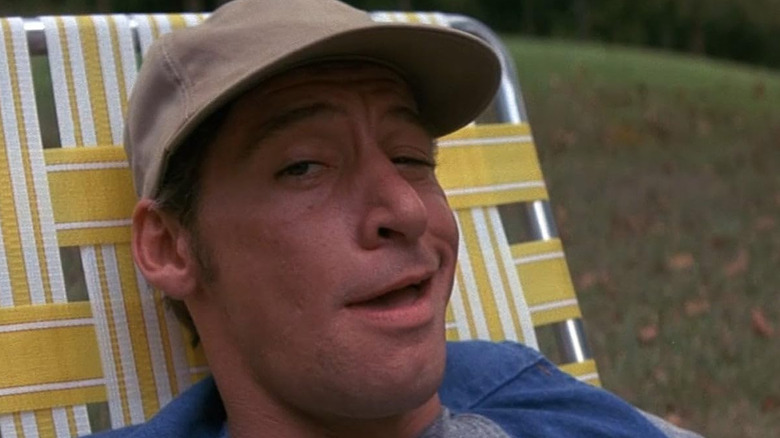 Ernest (Jim Varney) smiles in a cocky way in Ernest Goes To Camp