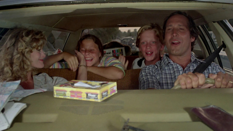 Beverly D'Angelo as Ellen, Dana Barron as Audrey, Anthony Michael Hall as Rusty, and Chevy Chase as Clark in the car in Vacation