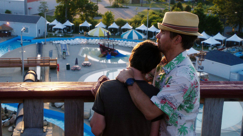 Sam Rockwell as Owen hugging Liam James as Duncan overlooking a water park in The Way Way Back
